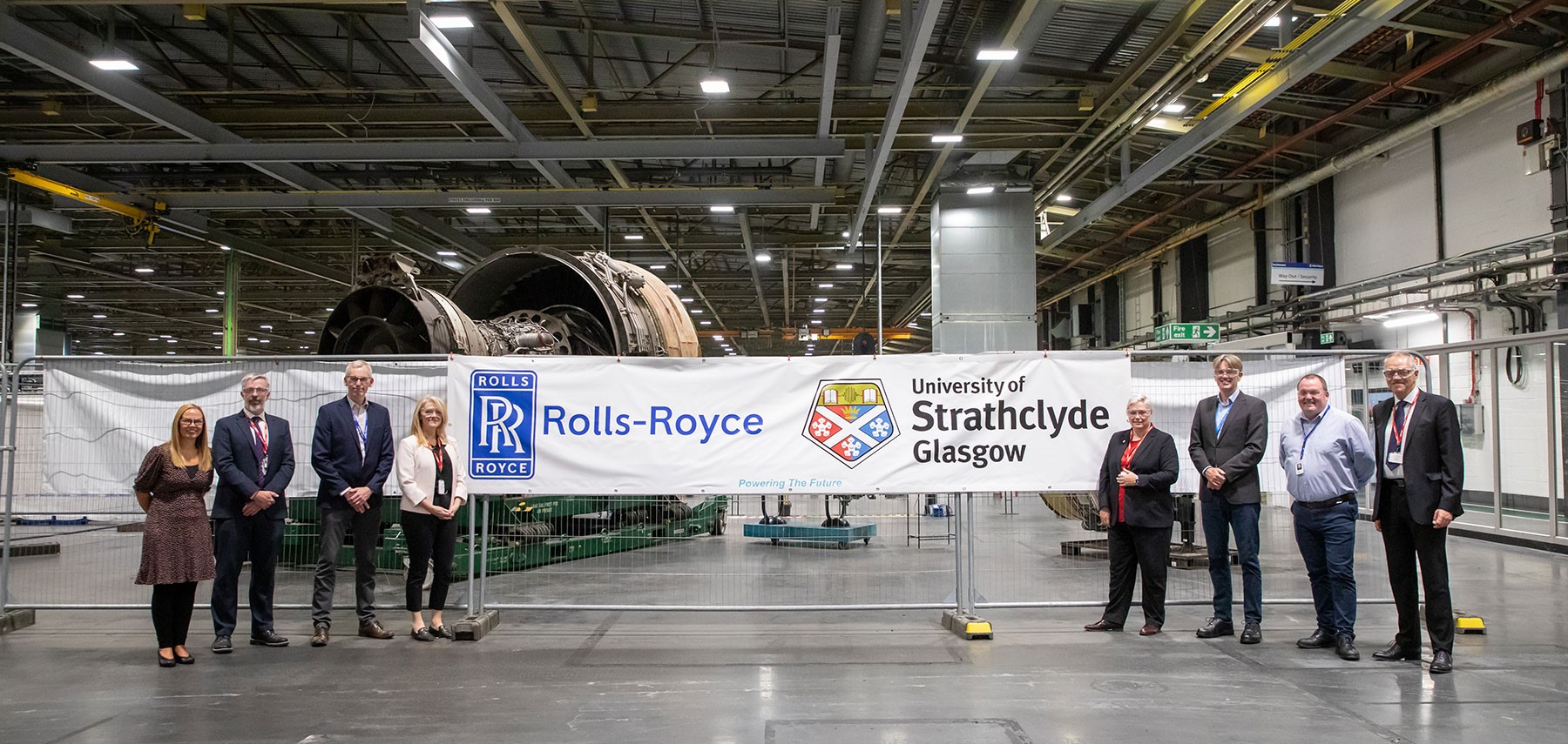 Rolls-Royce and Strathclyde staff standing together. Left to right: Lindsay Gardner – Senior Business Partner, Rolls-Royce; Matthew Maynard, University of Strathclyde; Nigel Bird - Executive Vice President, Rolls-Royce; Jacqueline Redmond, Executive Director, PNDC, University of Strathclyde; Gillian Docherty, Chief Commercial Officer, University of Strathclyde; Rob Watson, Head of Civil Aerospace, Rolls-Royce; Gordon Hutcheson, Manufacturing Executive, Rolls-Royce; and Derek Boyd, Project Director, University of Strathclyde. Rolls-Royce and Strathclyde staff standing together. Left to right: Lindsay Gardner – Senior Business Partner, Rolls-Royce; Matthew Maynard, University of Strathclyde; Nigel Bird - Executive Vice President, Rolls-Royce; Jacqueline Redmond, Executive Director, PNDC, University of Strathclyde; Gillian Docherty, Chief Commercial Officer, University of Strathclyde; Rob Watson, Head of Civil Aerospace, Rolls-Royce; Gordon Hutcheson, Manufacturing Executive, Rolls-Royce; and Derek Boyd, Project Director, University of Strathclyde.