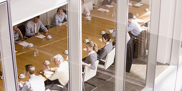 View of business people sitting in conference room. View of business people sitting in conference room.