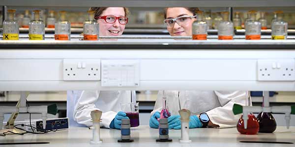 Two students in science lab. Two students in science lab.